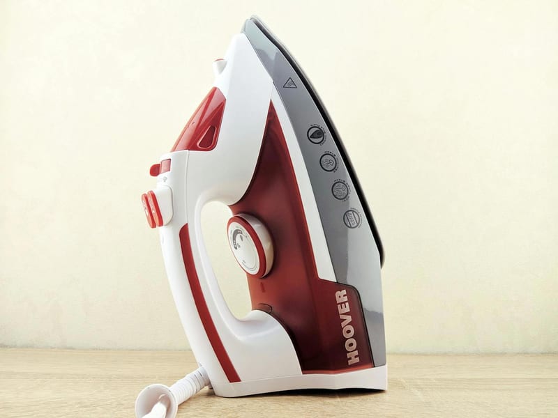 a hoover iron sits on a wooden table