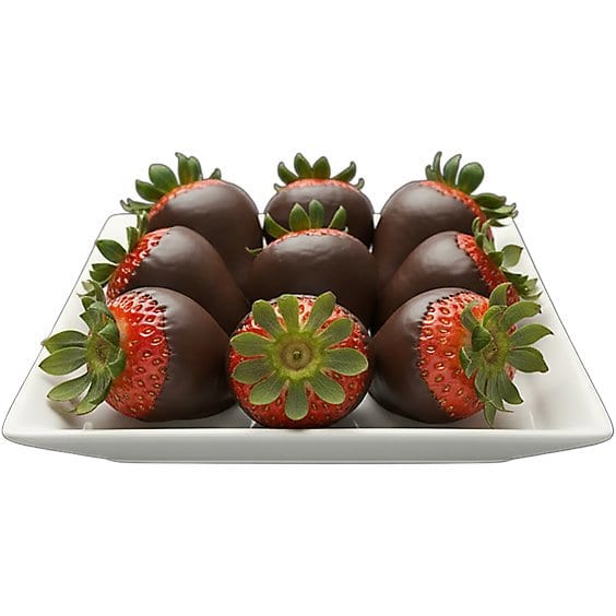 Chocolate-covered strawberries arranged on a white square plate