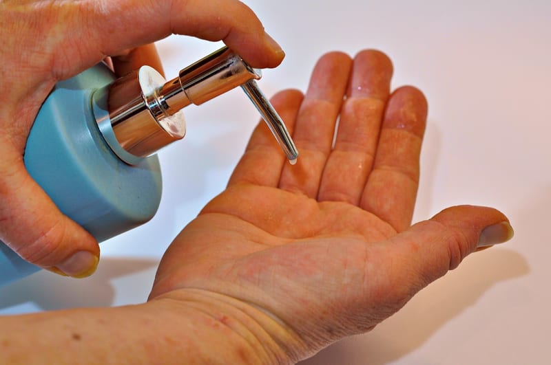 a person is applying soap to another person 's hand