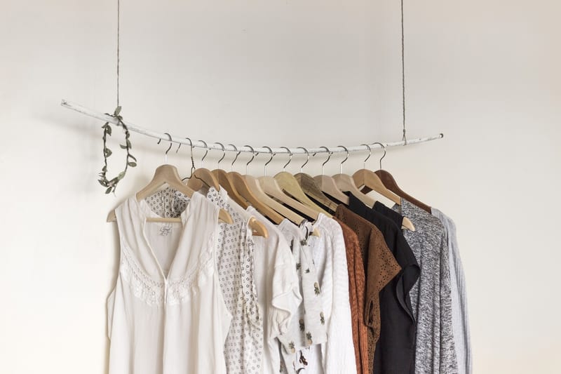 clothes hanging on a rack with one that says ' abercrombie & fitch ' on it