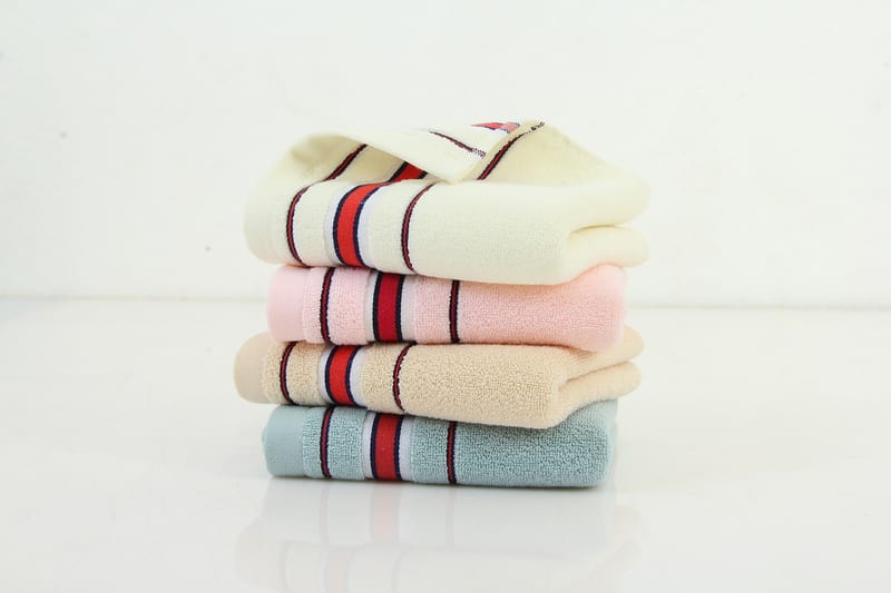 four striped towels are stacked on top of each other