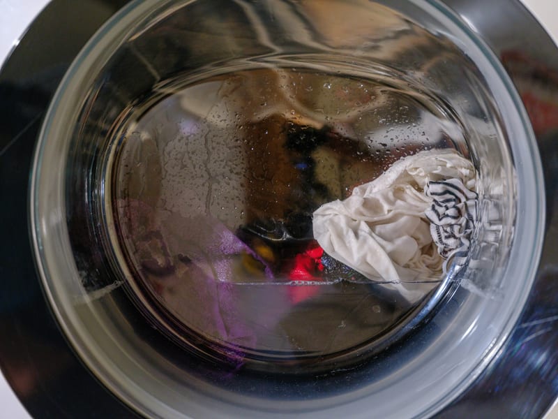 the inside of a washing machine with clothes in it