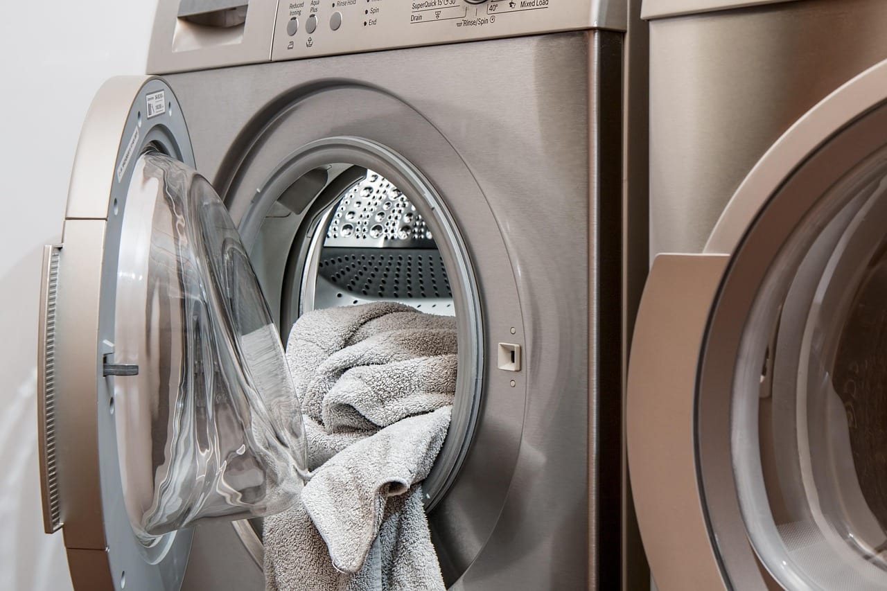 Front-loading washing machine with the door open and towels inside