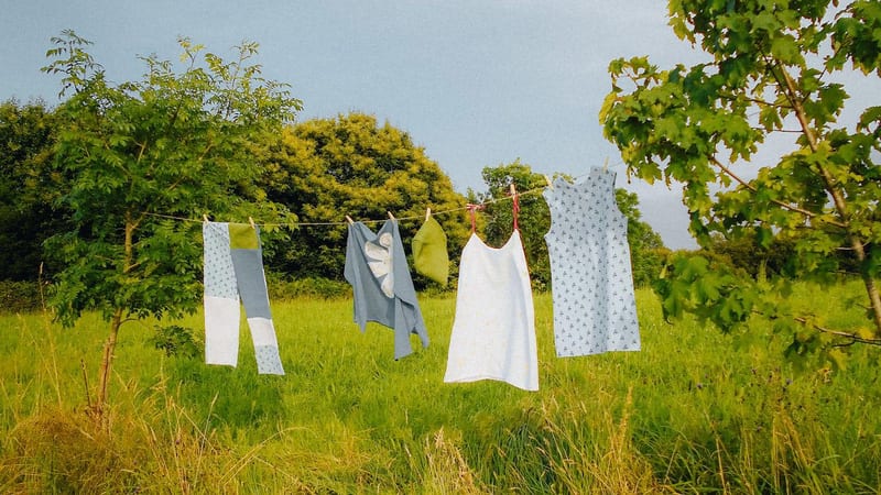 clothes hanging on a clothes line in a field