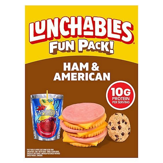 Lunchables Fun Pack Ham & American box showing stacked ham, cheese, and crackers with a Capri Sun Fruit Punch pouch and a chocolate chip cookie
