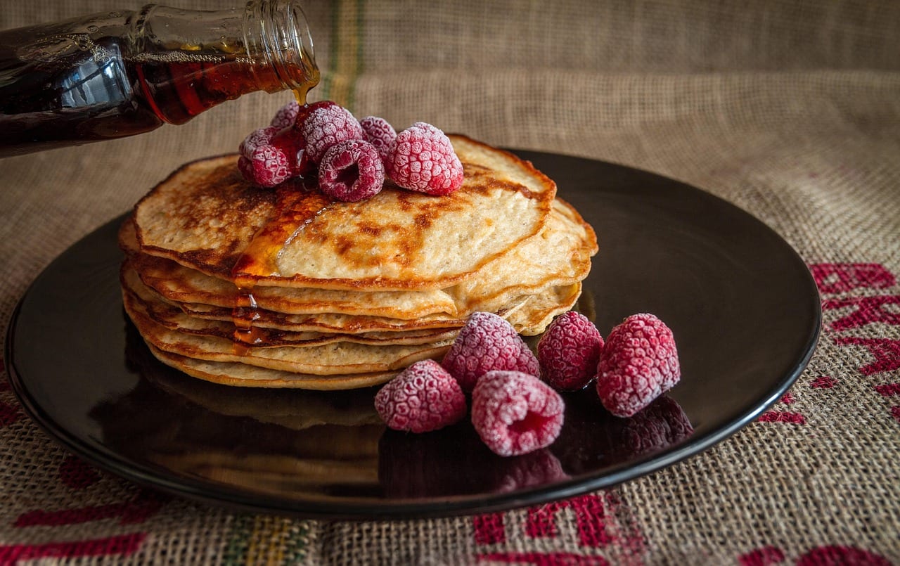 pancakes, maple syrup, raspberries, breakfast, pouring syrup, plate, breakfast plate, stack, stack of pancakes, breakfast food, breakfast meal, sweet, food, delicious, morning, tasty, fruits, food photography
